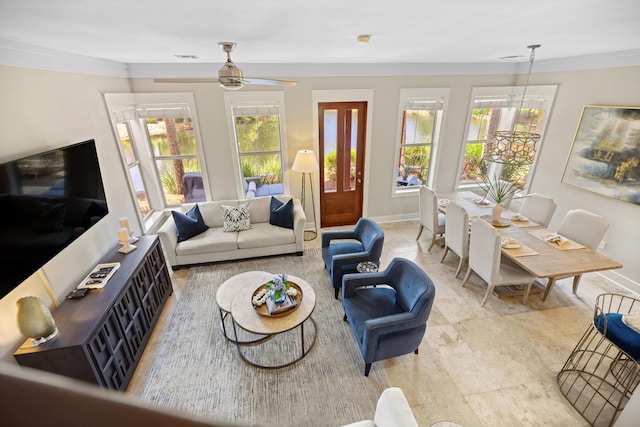 8585 Magnolia Bay Ln, Miramar Beach, FL 32550 - living area featuring healthy amount of natural light, crown molding, ceiling fan, and baseboards