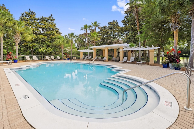 8585 Magnolia Bay Ln, Miramar Beach, FL 32550 - community pool featuring a pergola, a patio area, and view of wooded area