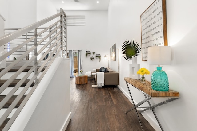 130 Durango Rd Unit 104, Destin, FL 32541 - hall with a high ceiling, dark wood-type flooring, baseboards, recessed lighting, and stairway