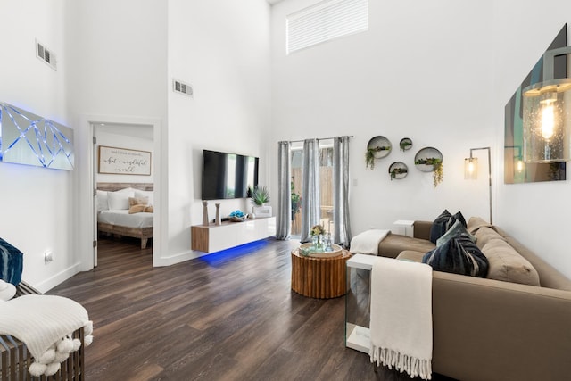 130 Durango Rd Unit 104, Destin, FL 32541 - living area with plenty of natural light, a high ceiling, dark wood-style flooring, and baseboards