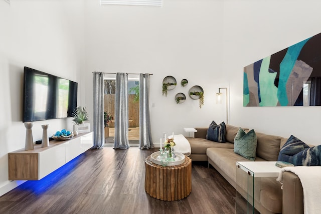 130 Durango Rd Unit 104, Destin, FL 32541 - living room featuring wood finished floors, a high ceiling, and baseboards