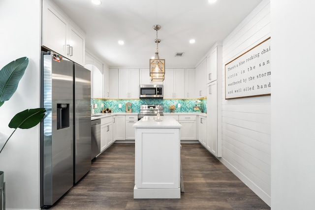 130 Durango Rd Unit 104, Destin, FL 32541 - kitchen featuring appliances with stainless steel finishes, light countertops, recessed lighting, white cabinetry, and backsplash