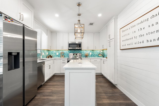130 Durango Rd Unit 104, Destin, FL 32541 - kitchen with stainless steel appliances, a sink, decorative backsplash, white cabinets, and recessed lighting