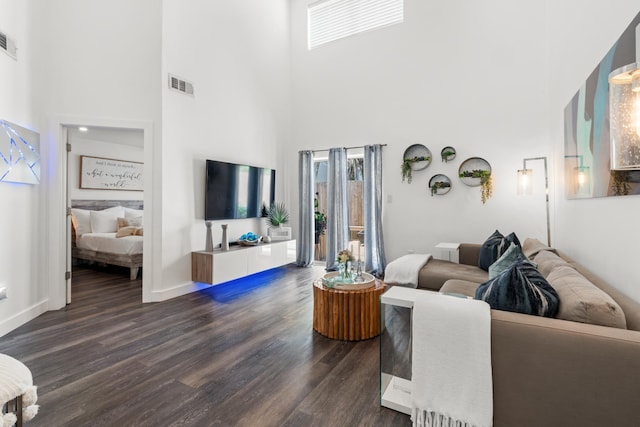 130 Durango Rd Unit 104, Destin, FL 32541 - living area with a high ceiling, dark wood-style floors, and baseboards