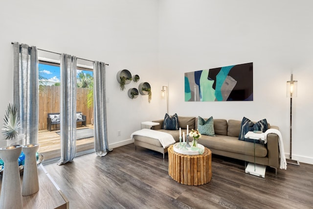 130 Durango Rd Unit 104, Destin, FL 32541 - living room featuring wood finished floors, baseboards, and a towering ceiling