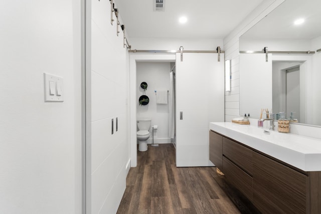 130 Durango Rd Unit 104, Destin, FL 32541 - bathroom with vanity, toilet, and wood finished floors