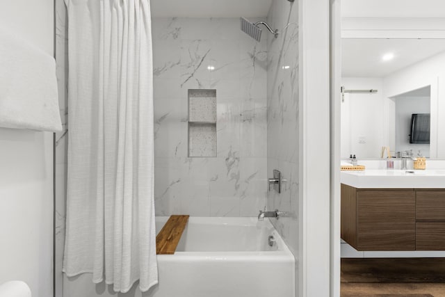 130 Durango Rd Unit 104, Destin, FL 32541 - bathroom featuring vanity, shower / bathtub combination with curtain, and wood finished floors