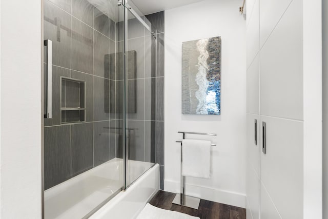 130 Durango Rd Unit 104, Destin, FL 32541 - bathroom featuring enclosed tub / shower combo and wood finished floors