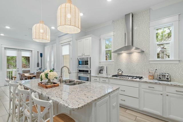 58 E Milestone Dr Unit B, Inlet Beach, FL 32461 - kitchen with stainless steel appliances, a sink, wall chimney range hood, backsplash, and healthy amount of natural light