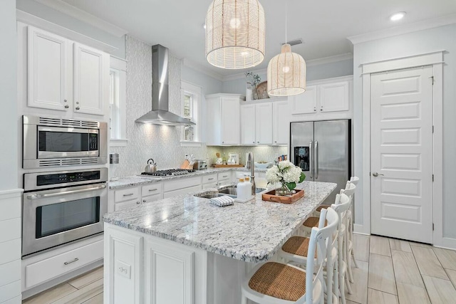 58 E Milestone Dr Unit B, Inlet Beach, FL 32461 - kitchen with stainless steel appliances, wall chimney range hood, white cabinetry, a sink, and backsplash