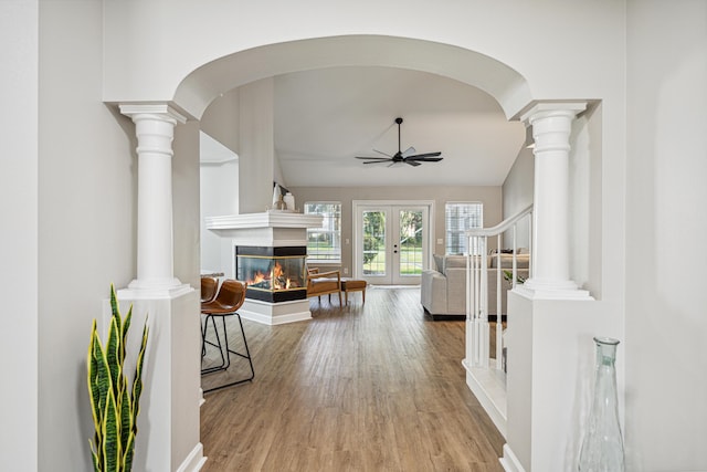 865 Indigo Loop, Destin, FL 32550 - entrance foyer with a multi sided fireplace, wood finished floors, french doors, a ceiling fan, and arched walkways