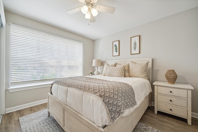 865 Indigo Loop, Destin, FL 32550 - bedroom with baseboards, multiple windows, and wood finished floors