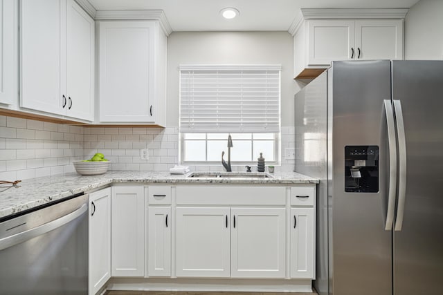 865 Indigo Loop, Destin, FL 32550 - kitchen with stainless steel appliances, a sink, white cabinets, decorative backsplash, and light stone countertops