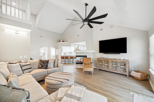 865 Indigo Loop, Destin, FL 32550 - living area featuring high vaulted ceiling, arched walkways, wood finished floors, stairway, and ceiling fan