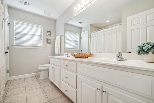 865 Indigo Loop, Destin, FL 32550 - bathroom with double vanity, toilet, tile patterned floors, baseboards, and a shower with shower curtain