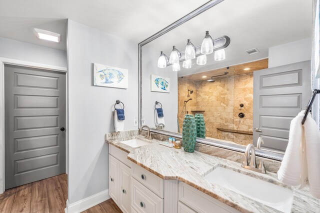 5209 Beachwalk Dr, Miramar Beach, FL 32550 - full bath featuring double vanity, tiled shower, wood finished floors, and baseboards