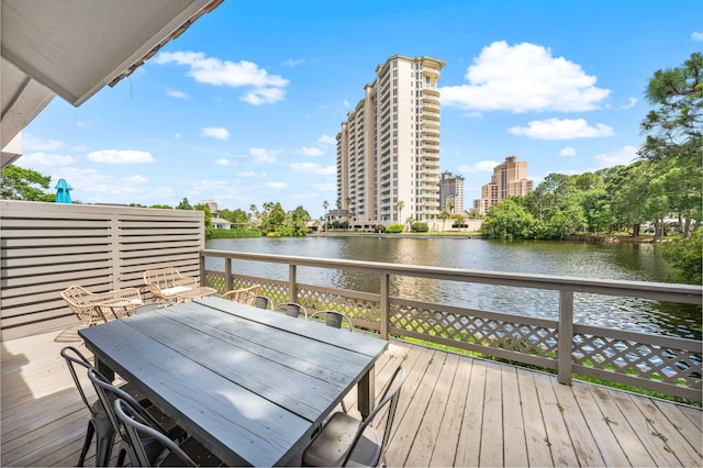 5209 Beachwalk Dr, Miramar Beach, FL 32550 - wooden deck featuring a water view and outdoor dining space