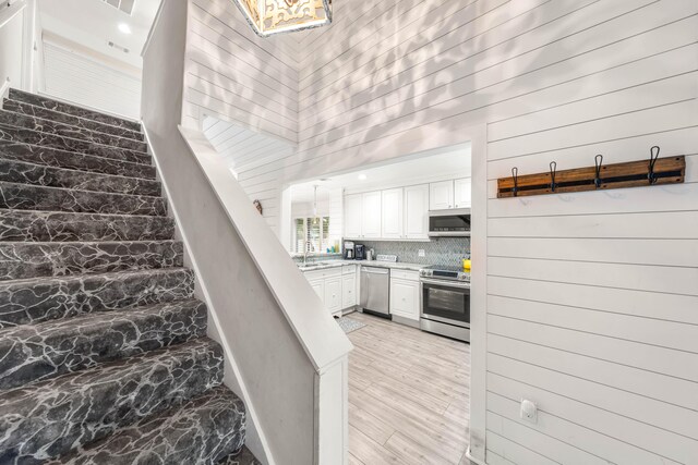 5209 Beachwalk Dr, Miramar Beach, FL 32550 - stairs with wood finished floors and wood walls