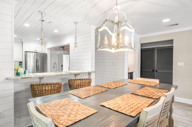 5209 Beachwalk Dr, Miramar Beach, FL 32550 - unfurnished dining area with light wood-type flooring, baseboards, a chandelier, recessed lighting, and crown molding