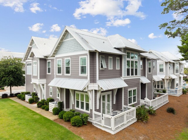 25 E Pine Lands Loop Unit B, Inlet Beach, FL 32461 - view of front of house featuring metal roof, a front yard, and a residential view