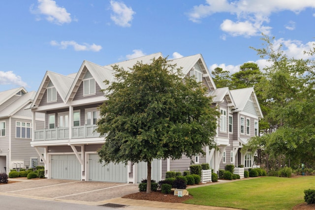 25 E Pine Lands Loop Unit B, Inlet Beach, FL 32461 - townhome / multi-family property featuring an attached garage, a front yard, and driveway
