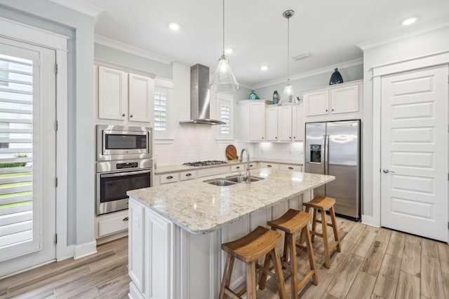 25 E Pine Lands Loop Unit B, Inlet Beach, FL 32461 - kitchen featuring stainless steel appliances, wall chimney exhaust hood, a sink, light wood-style flooring, and crown molding
