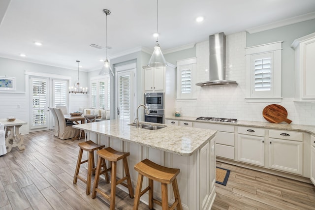 25 E Pine Lands Loop Unit B, Inlet Beach, FL 32461 - kitchen featuring wall chimney range hood, a sink, stainless steel appliances, decorative backsplash, and crown molding