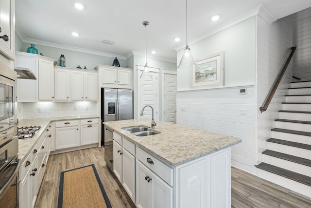 25 E Pine Lands Loop Unit B, Inlet Beach, FL 32461 - kitchen featuring stainless steel appliances, a sink, light wood-style floors, ornamental molding, and white cabinets