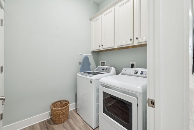 25 E Pine Lands Loop Unit B, Inlet Beach, FL 32461 - laundry area featuring cabinet space, independent washer and dryer, light wood-type flooring, and baseboards