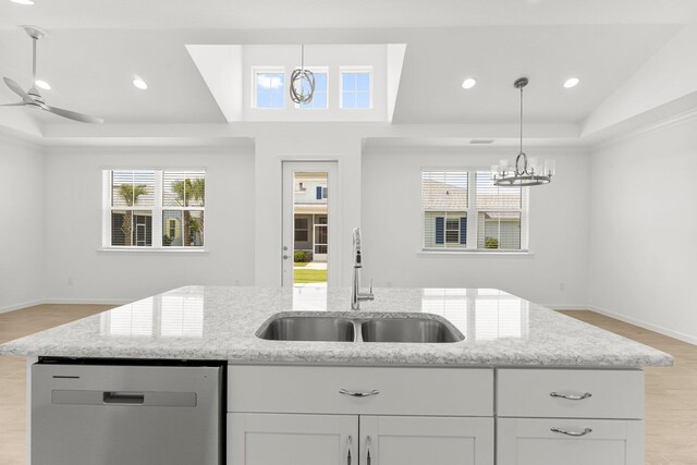 8454 Dreams Float Ct, Panama City Beach, FL 32413 - kitchen with stainless steel dishwasher, a sink, a chandelier, a tray ceiling, and recessed lighting