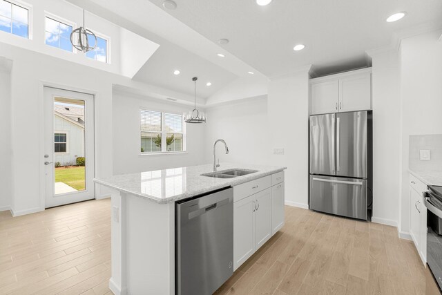 8454 Dreams Float Ct, Panama City Beach, FL 32413 - kitchen with appliances with stainless steel finishes, a sink, light wood-style flooring, recessed lighting, and white cabinetry