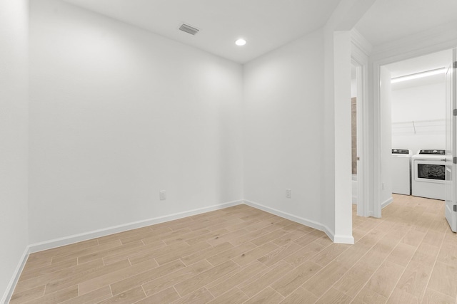 8454 Dreams Float Ct, Panama City Beach, FL 32413 - spare room featuring light wood finished floors, baseboards, independent washer and dryer, and recessed lighting