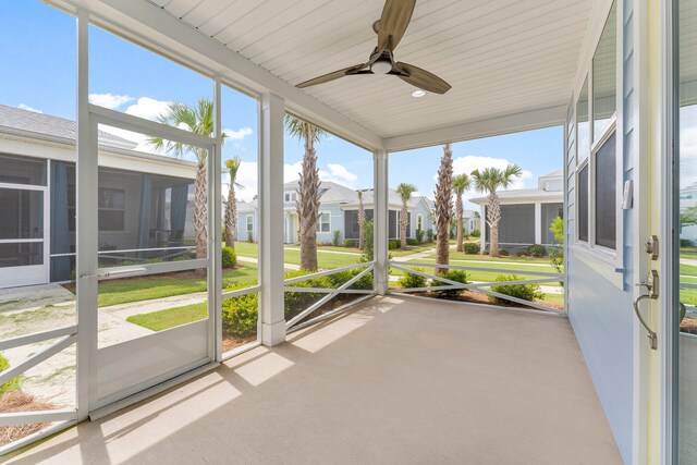 8454 Dreams Float Ct, Panama City Beach, FL 32413 - unfurnished sunroom with healthy amount of natural light, ceiling fan, and a residential view