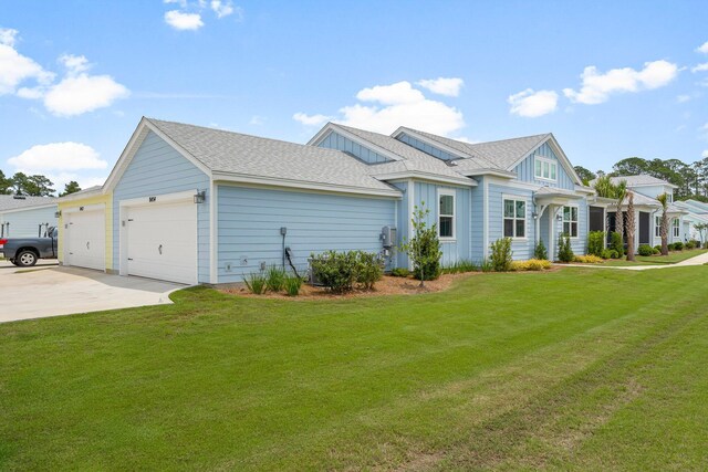 8454 Dreams Float Ct, Panama City Beach, FL 32413 - view of front facade with board and batten siding, driveway, a garage, and a front lawn