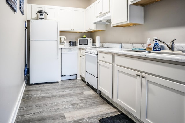364 Bluefish Dr Unit 102, Fort Walton Beach, FL 32548 - kitchen featuring white appliances, under cabinet range hood, light countertops, and a sink