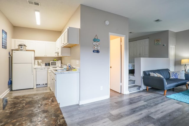364 Bluefish Dr Unit 102, Fort Walton Beach, FL 32548 - kitchen with white appliances, light wood finished floors, white cabinets, and baseboards