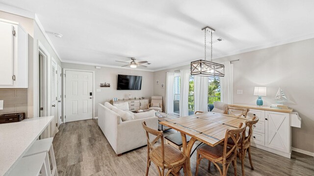 11 Beachside Dr Unit 722, Santa Rosa Beach, FL 32459 - dining area with light wood-type flooring, crown molding, and ceiling fan