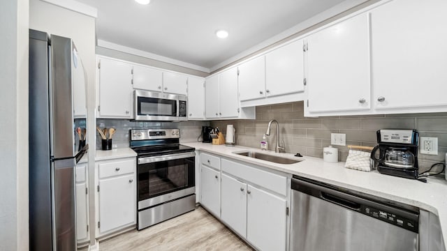 11 Beachside Dr Unit 722, Santa Rosa Beach, FL 32459 - kitchen with stainless steel appliances, decorative backsplash, white cabinets, light wood-style floors, and recessed lighting