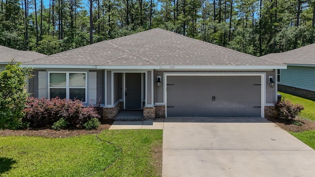 720 Riverwalk Cir, Freeport, FL 32439 - single story home with roof with shingles, a garage, concrete driveway, a front yard, and stone siding