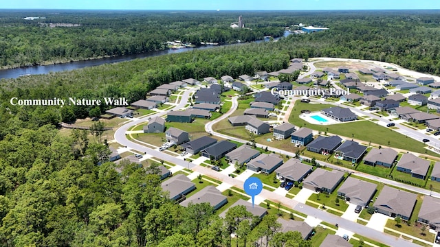 720 Riverwalk Cir, Freeport, FL 32439 - aerial view of property and surrounding area with a heavily wooded area, a nearby body of water, and nearby suburban area