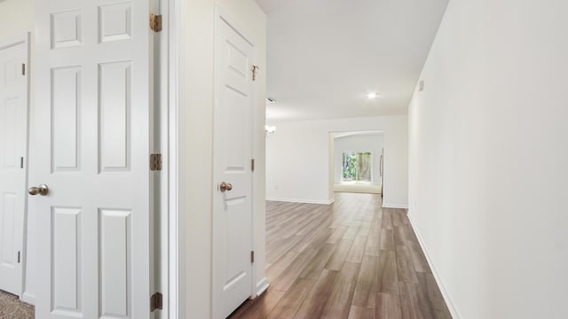 720 Riverwalk Cir, Freeport, FL 32439 - corridor featuring wood finished floors and baseboards