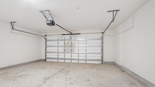 720 Riverwalk Cir, Freeport, FL 32439 - garage featuring a garage door opener and baseboards