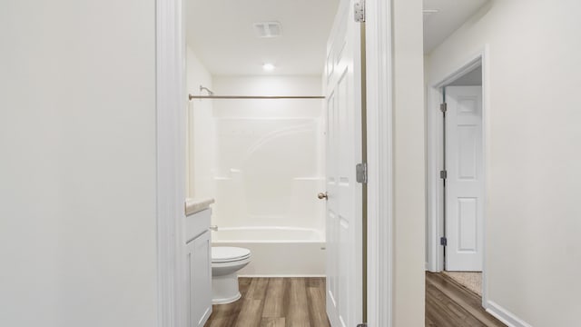 720 Riverwalk Cir, Freeport, FL 32439 - full bathroom featuring toilet, wood finished floors, vanity, and shower / tub combination