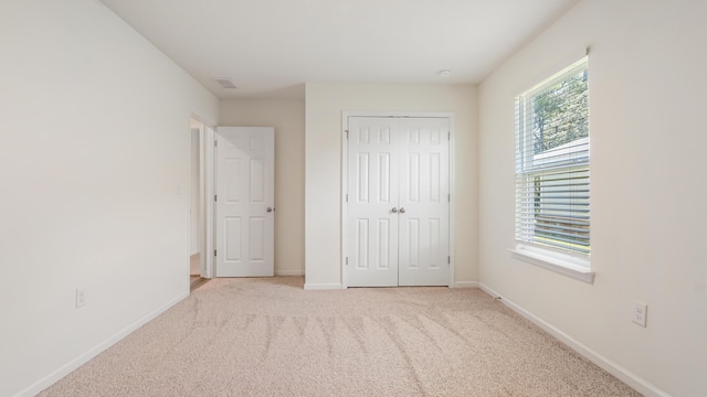 720 Riverwalk Cir, Freeport, FL 32439 - unfurnished bedroom with a closet, carpet flooring, and baseboards