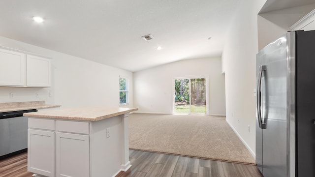 720 Riverwalk Cir, Freeport, FL 32439 - kitchen featuring appliances with stainless steel finishes, vaulted ceiling, light wood finished floors, light countertops, and open floor plan