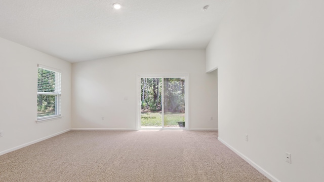 720 Riverwalk Cir, Freeport, FL 32439 - spare room featuring vaulted ceiling, plenty of natural light, light colored carpet, and baseboards