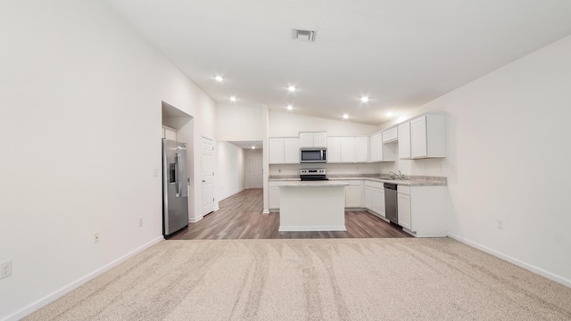720 Riverwalk Cir, Freeport, FL 32439 - kitchen featuring stainless steel appliances, a kitchen island, a sink, baseboards, and lofted ceiling