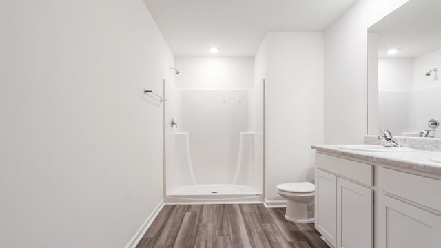 720 Riverwalk Cir, Freeport, FL 32439 - bathroom with a shower, wood finished floors, vanity, toilet, and baseboards