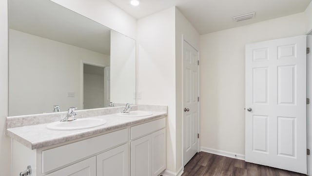 720 Riverwalk Cir, Freeport, FL 32439 - full bathroom featuring double vanity, wood finished floors, and baseboards