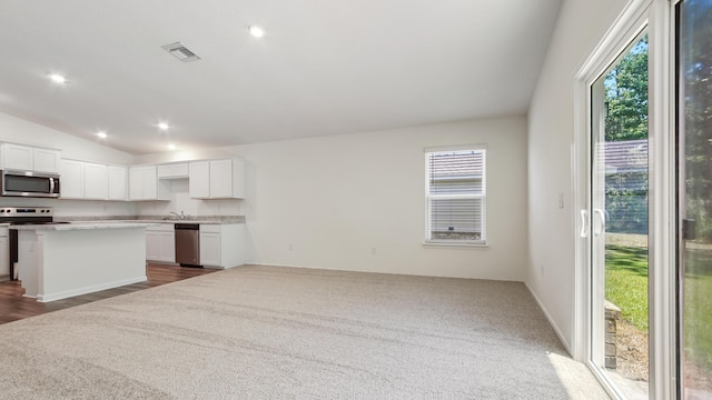 720 Riverwalk Cir, Freeport, FL 32439 - kitchen with appliances with stainless steel finishes, plenty of natural light, lofted ceiling, open floor plan, and white cabinets
